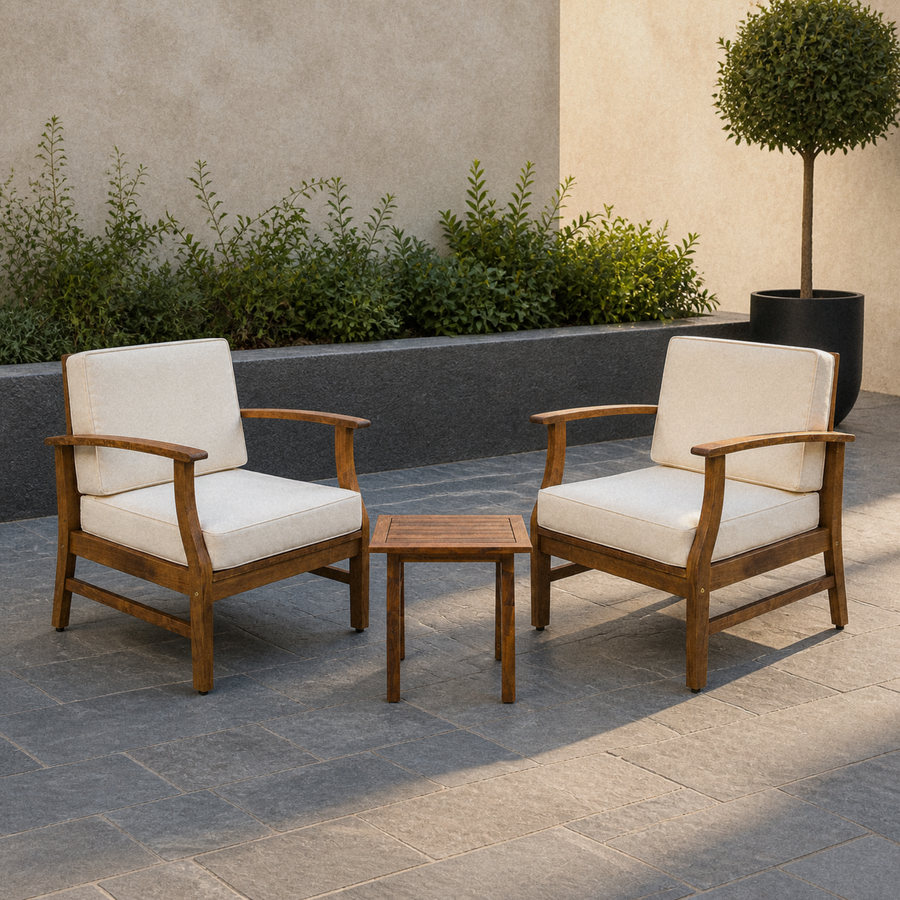 Room | Two warm-brown acacia club chairs with cream cushions and one slatted side table in a cool bluestone courtyard