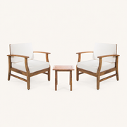 Front | Two warm-brown acacia club chairs with cream cushions and one slatted side table on clean studio ground