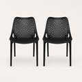 Studio front | Two matching Black perforated molded-plastic stacking chairs, straight-on