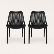 Studio front | Two matching Black perforated molded-plastic stacking chairs, straight-on