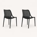 Studio side | Two Black stacking chairs in side and rear profile, showing shell depth and four legs each