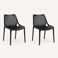 Studio three-quarter | Two Black molded-plastic stacking chairs showing the diamond lattice and seat depth