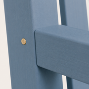 Detail | round brass-colored fastener at the blue arm-to-post joint