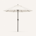 Front | one off-white octagonal umbrella with dark bronze pole, vented crown and crank on a clean studio ground