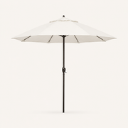 Front | one off-white octagonal umbrella with dark bronze pole, vented crown and crank on a clean studio ground