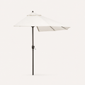 Studio side | open off-white octagonal umbrella in side profile showing canopy projection, dark bronze pole, ribs and silver crank