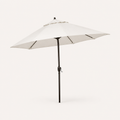 Studio three-quarter | open off-white octagonal umbrella showing canopy depth, vented crown, dark ribs, bronze pole and crank