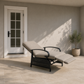 Scale | reclined chair with its footrest extended beside a full exterior doorway