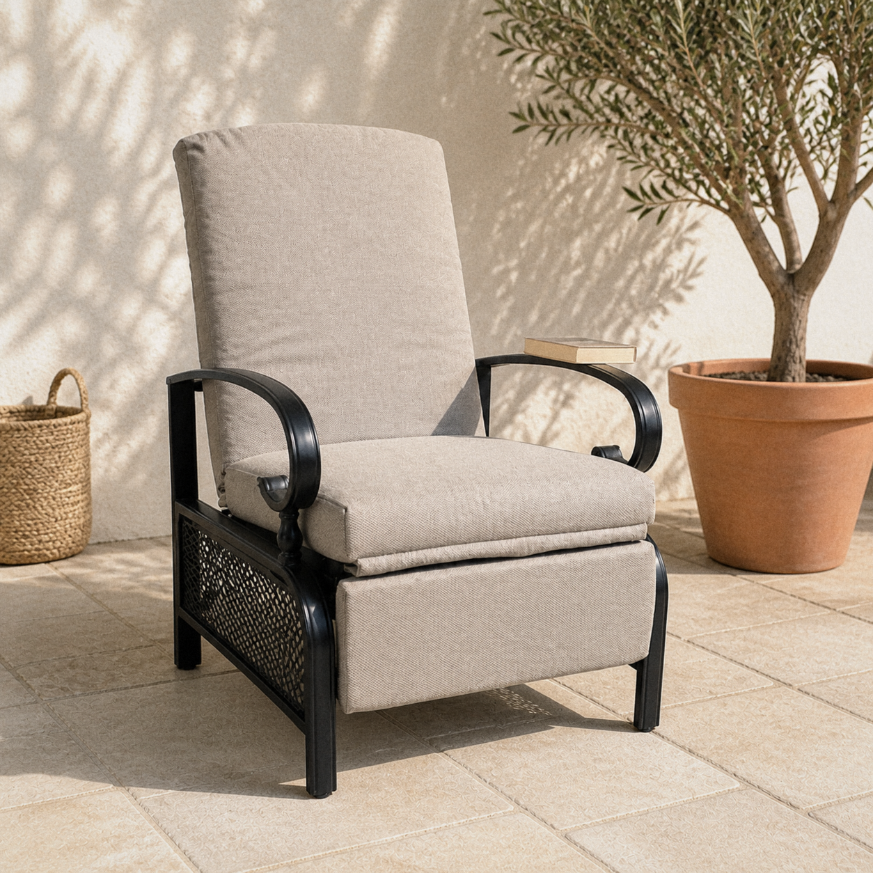 Terrace | upright beige-cushioned patio recliner on limestone pavers beside an olive tree