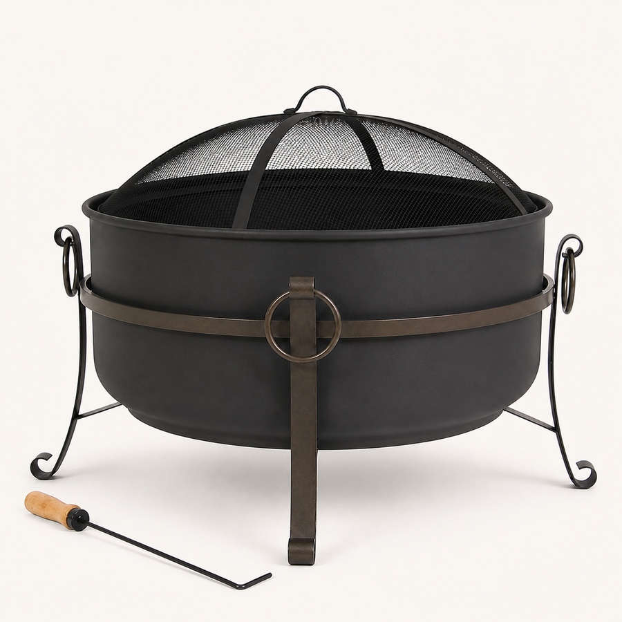 Studio front | Dark steel cauldron fire pit with mesh spark screen, ring latch, three curled legs, and poker