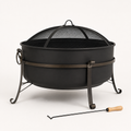 Studio side | Dark steel cauldron fire pit showing bowl profile, mesh screen, side handle, curled legs, and poker