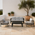 Warm Mediterranean courtyard | black aluminum 3-seat sofa, two armchairs, and slatted coffee table on pale limestone