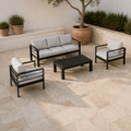 Mediterranean courtyard angle | black aluminum four-piece conversation set with olive tree and limestone pavers