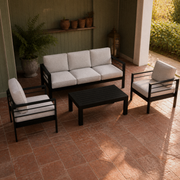 Sage veranda | black aluminum four-piece conversation set on red-clay tiles with a garden doorway