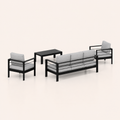 Studio side | rear profile of the black aluminum sofa, two armchairs, and slatted coffee table