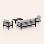Studio side | rear profile of the black aluminum sofa, two armchairs, and slatted coffee table