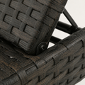 Hardware | true close-up of the dark metal backrest pivot beside the woven wicker rail