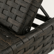 Hardware | true close-up of the dark metal backrest pivot beside the woven wicker rail