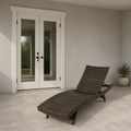 Scale | dark wicker chaise lounge beside a fully visible white exterior doorway for scale