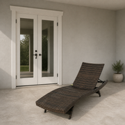 Scale | dark wicker chaise lounge beside a fully visible white exterior doorway for scale