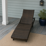 In a room | dark wicker chaise lounge on a blue-gray porch beside a white column