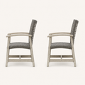 Studio side | Side profiles of two light gray-washed acacia club chairs with dark wicker seats