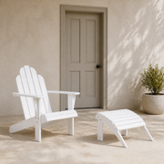 In scale | White Adirondack chair and matching ottoman beside a full height exterior door