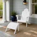 Porch | White Adirondack chair and ottoman on a blue gray clapboard porch with a sand rug and navy planter