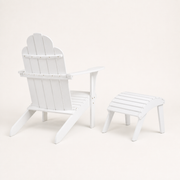 Rear angle | White Adirondack chair and matching ottoman from the right rear, showing back rails and slats