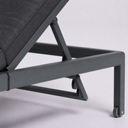 Recline hardware | Close view of the dark metal backrest support, aluminum rail and head-end wheel