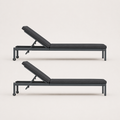 Studio side | Side profile of two dark gray reclining chaise lounges with raised back supports and wheels