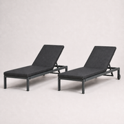 Studio three-quarter | Two dark gray chaise lounges showing rectangular rails, raised backs and head-end wheels