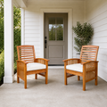 Scale | two warm-brown acacia dining armchairs with ivory seat cushions beside a full-height porch doorway for scale