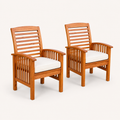 Studio | pair of warm-brown acacia dining armchairs with ivory seat cushions at a three-quarter studio angle