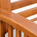 Texture | close crop of the acacia arm and back slats showing individual wood grain beside the ivory cushion