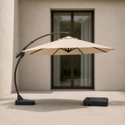 Scale | sand offset cantilever umbrella beside an uncropped full-height glass doorway, showing its scale with separate wheeled base