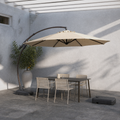 In a room | cool slate courtyard with Sand offset cantilever umbrella over a dark table and chairs, separate wheeled base at right
