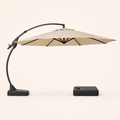 Side | side studio profile of open Sand cantilever umbrella, curved arm, mast foot, and separate wheeled base