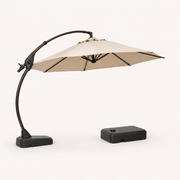 Studio | three-quarter studio view of open Sand cantilever umbrella showing underside ribs, curved arm, mast foot, and separate wheeled base