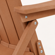 Close view | folding support joint, silver screws, and warm teak-tone chair surfaces filling the frame