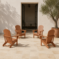 Scale | four warm teak-tone folding Adirondack chairs on a limestone courtyard in front of a full-height open doorway