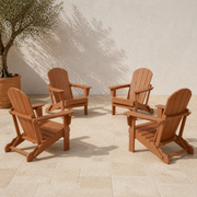 Set of four | four warm teak-tone folding Adirondack chairs arranged on pale limestone pavers beside a terracotta planter