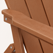 Close view | warm teak-tone chair arm edge, slatted back surface, and a silver fastener filling the frame