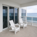 Scale | two white HDPE Adirondack chairs beside a full-height glazed doorway on a covered porch