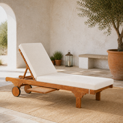 Sunlit courtyard | honey-brown eucalyptus chaise with a raised cream cushion, disc wheels, and pull-out tray