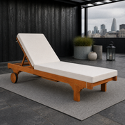 Rooftop terrace | eucalyptus chaise with a raised cream cushion on a gray rug beneath a black pergola