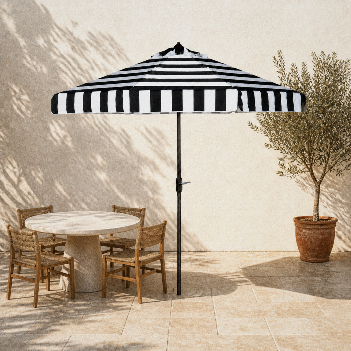 In a room | open black and white striped octagonal market umbrella shading a pale stone terrace table