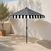 Angle | three-quarter terrace view of the open striped umbrella with pole and crank visible
