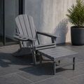Room | gray HDPE chair and matching ottoman in a cool slate courtyard beside a glass door