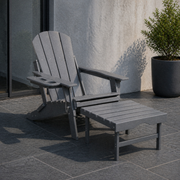 Room | gray HDPE chair and matching ottoman in a cool slate courtyard beside a glass door